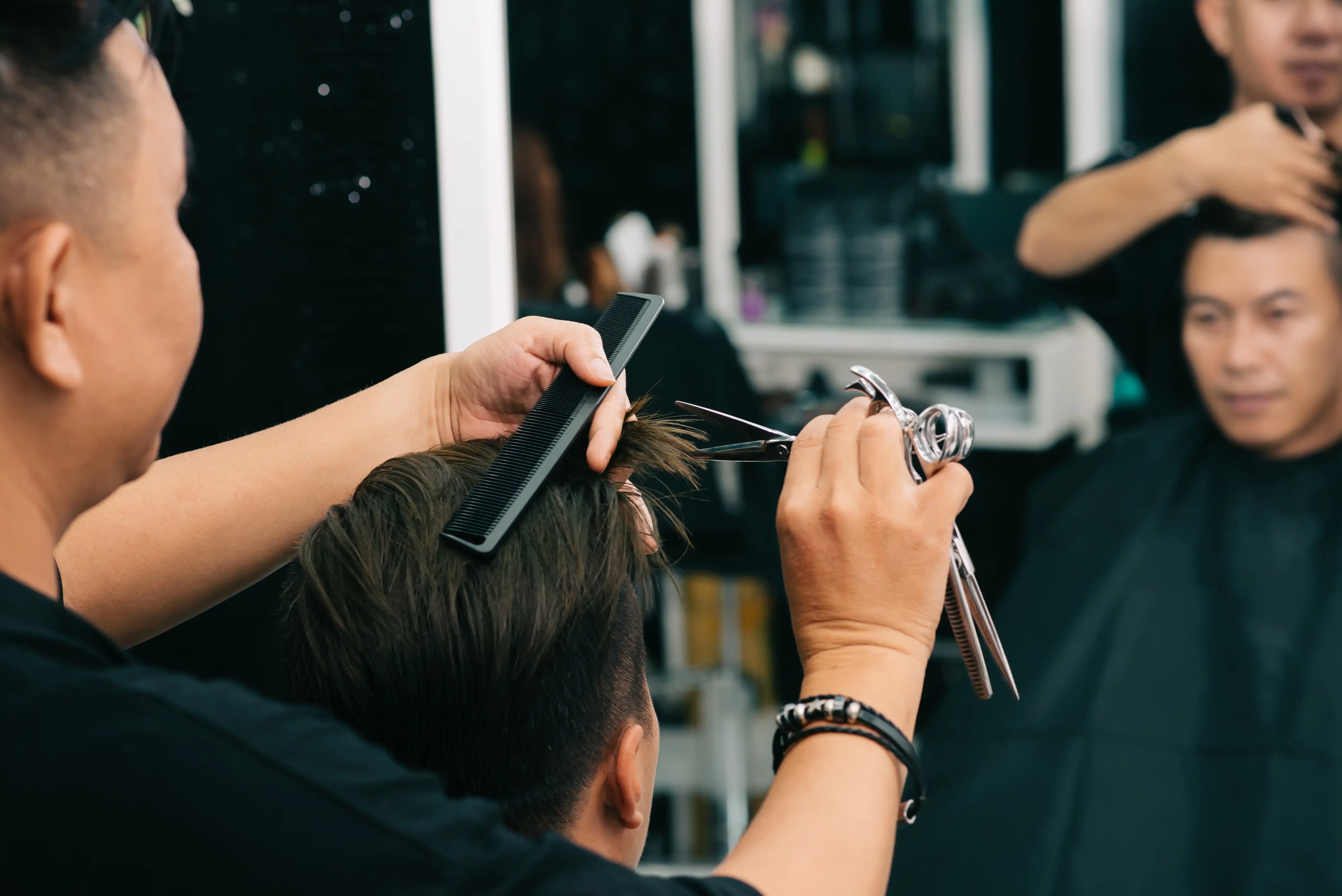https://www.freepik.com/free-photo/male-hairdresser-cutting-customer-s-hair-with-comp-scissors-front-mirror_5839695.htm